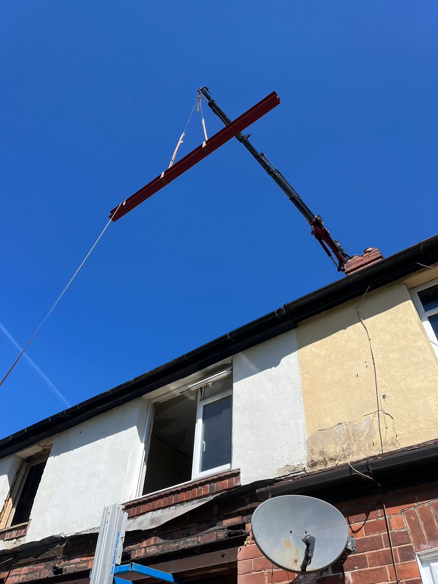 crane lifting an RSJ beam into place